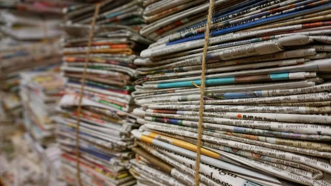stacked newspapers page header
